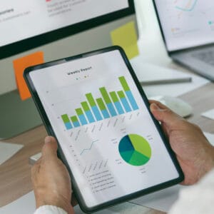 Business partnership coworkers using a tablet to analysis graph Siti web Ragusa Chi Siamo